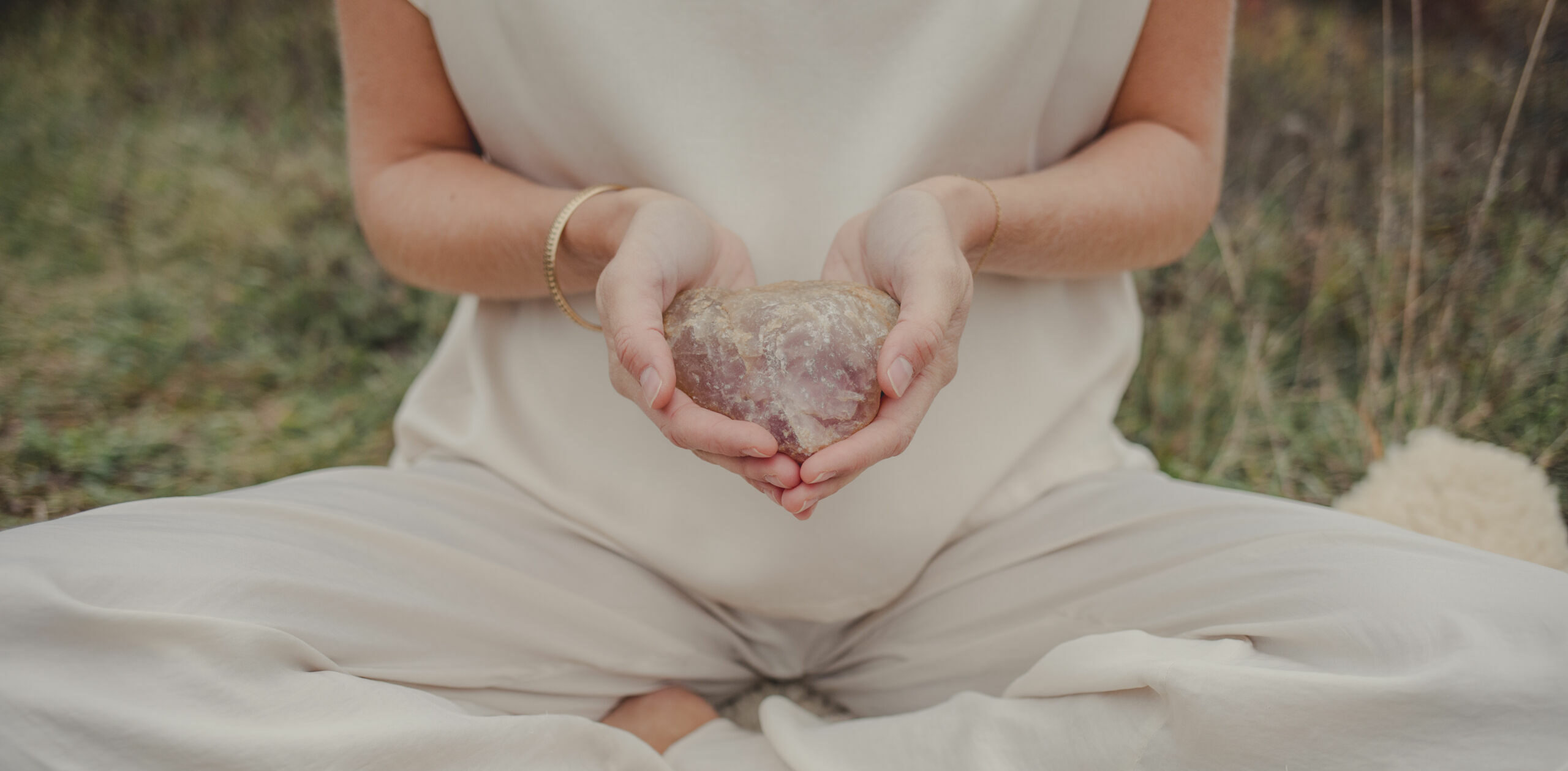 woman holding a crystal in her hands